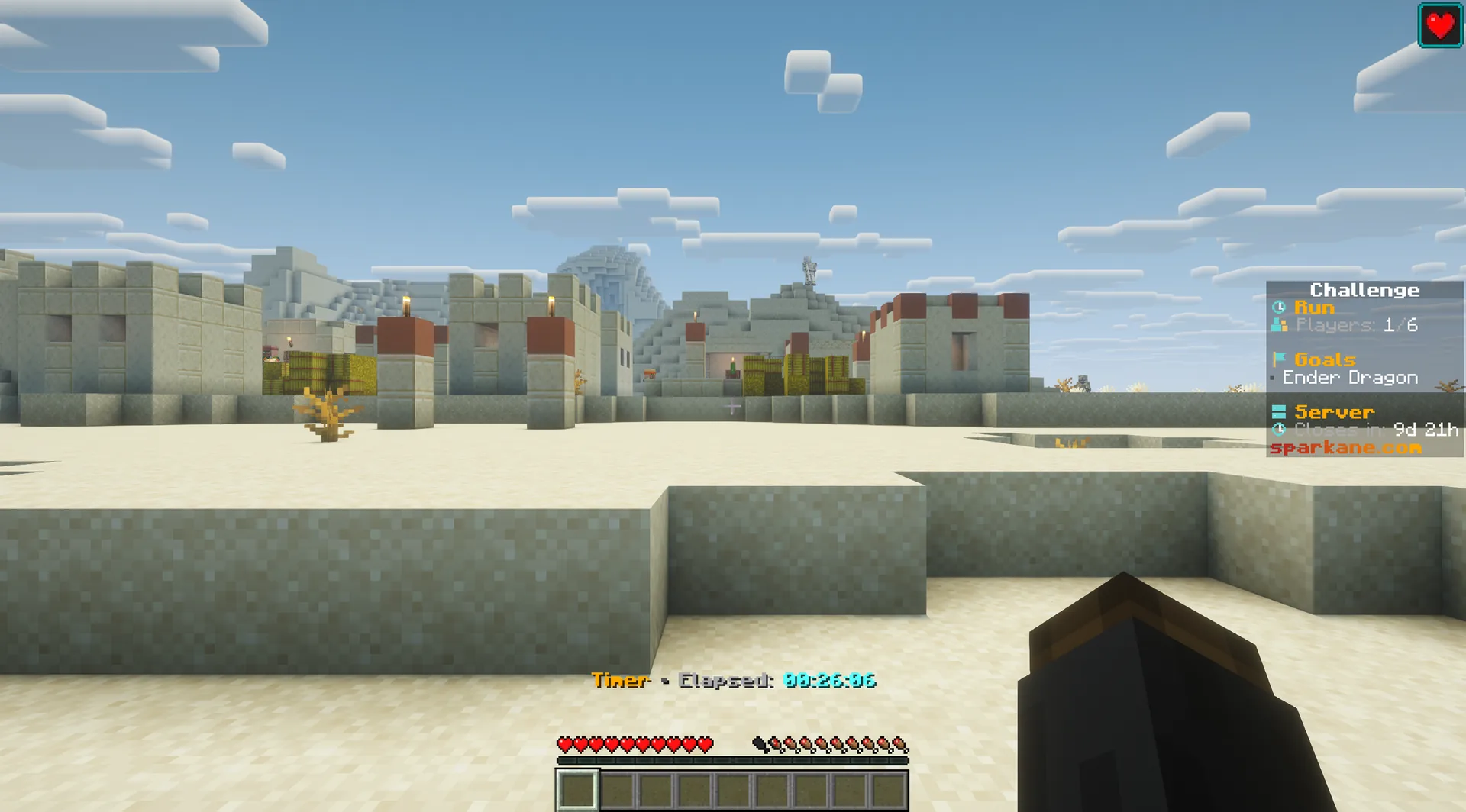 Desert village during an active run, with a red heart icon at the top right showing the assigned regeneration effect.