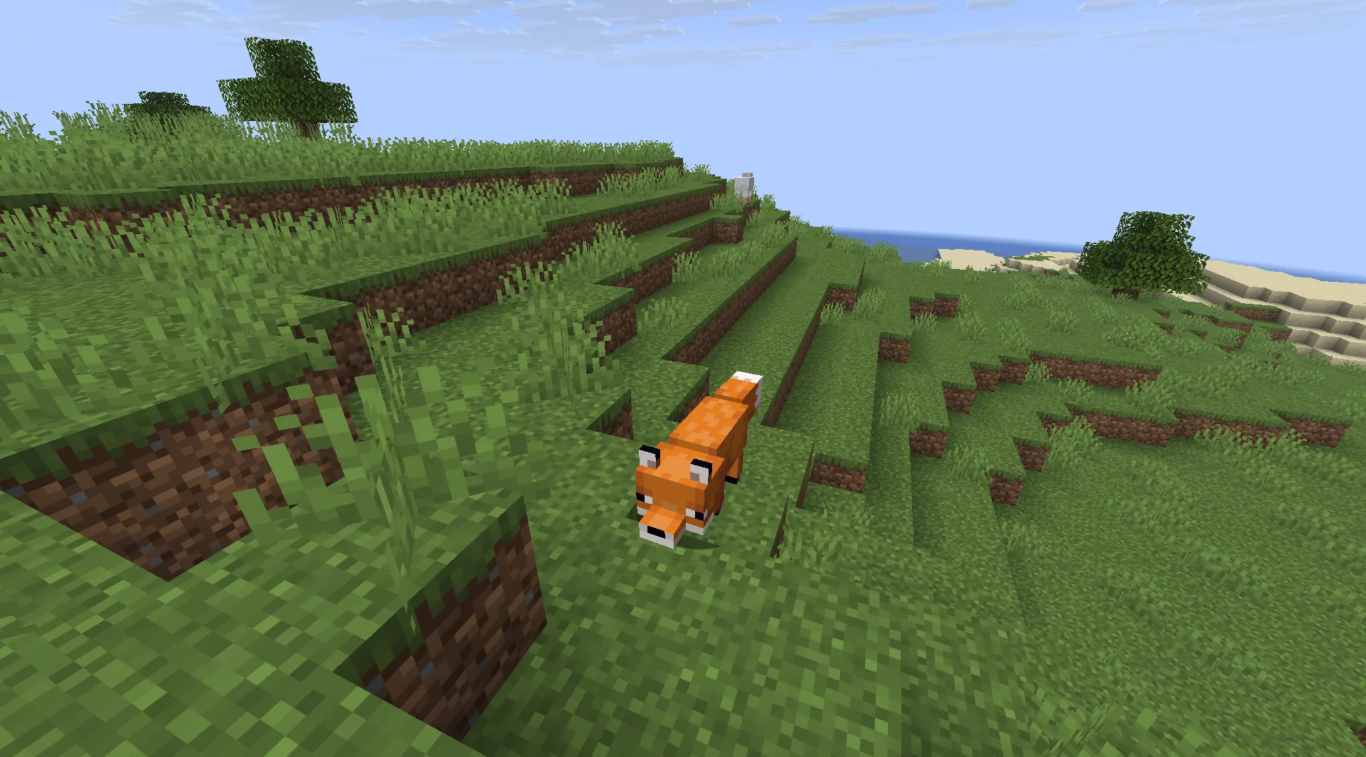 Gameplay scene with a fox on a grassy hillside above the coast.