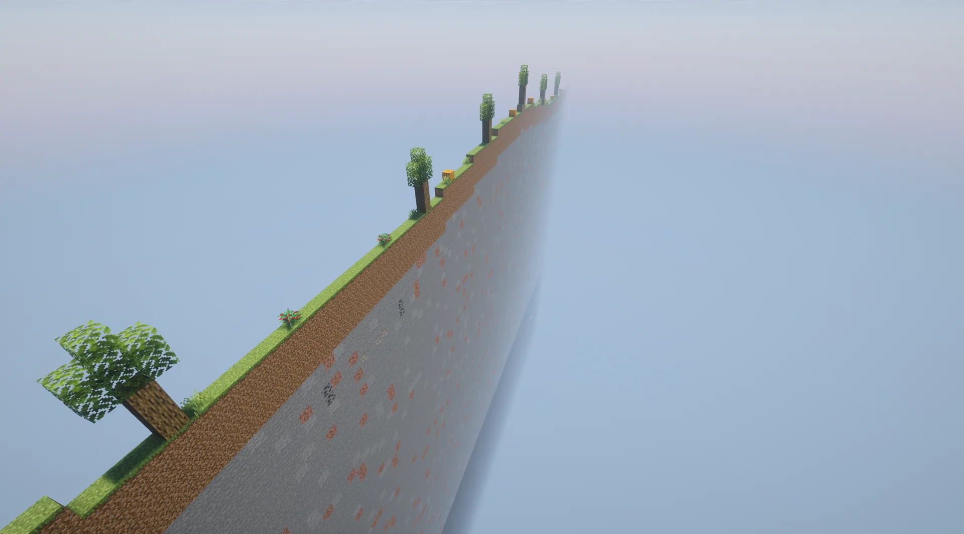 Long landscape strip only one block wide, with trees and ores exposed in its rocky side.